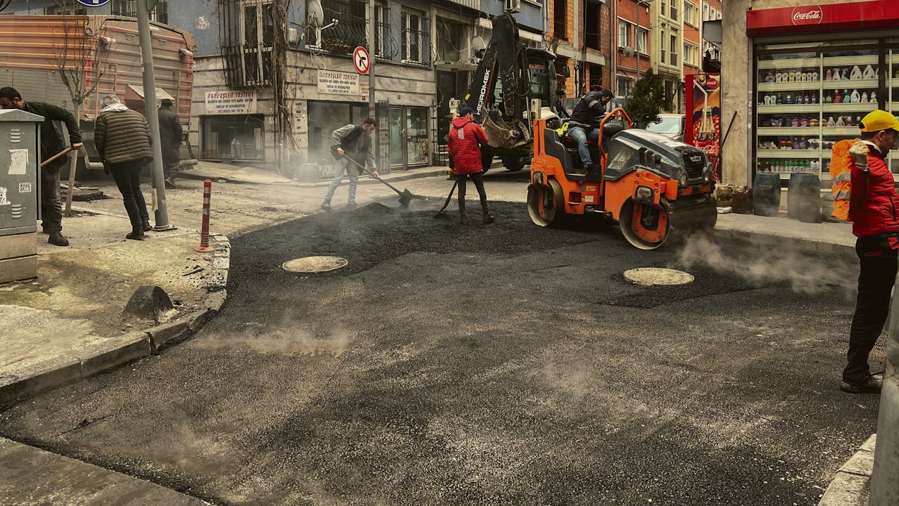 Men working on asphalt road construction in İstanbul street.